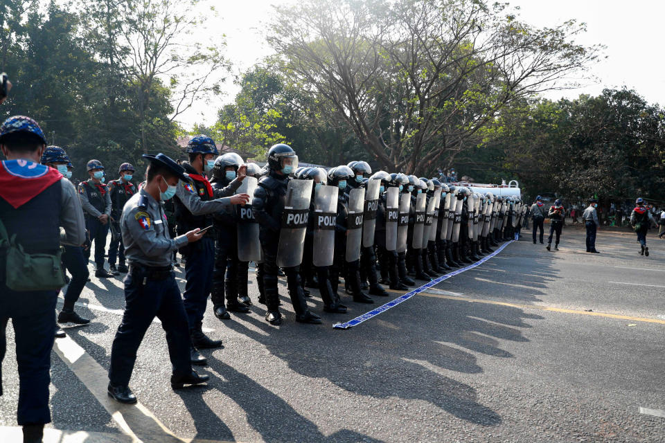 Riot police block the road in front of Yangon University in Yangon, Myanmar on Sunday, Feb. 7, 2021. Thousands of people rallied against the military takeover in Myanmar's biggest city on Sunday and demanded the release of Aung San Suu Kyi, whose elected government was toppled by the army that also imposed an internet blackout. (AP Photo)