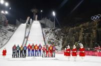 Ski Jumping - Pyeongchang 2018 Winter Olympics - Men’s Team Final - Alpensia Ski Jumping Centre - Pyeongchang, South Korea - February 19, 2018 - Gold medalists Daniel Andre Tande, Andreas Stjernen, Johann Andre Forfang and Robert Johansson of Norway, are flanked by Silver medalists Karl Geiger, Stephan Leyhe, Richard Freitag and Andreas Wellinger of Germany and Bronze medalists Maciej Kot, Stefan Hula, Dawid Kubacki and Kamil Stoch of Poland, as they celebrate during flower ceremony. REUTERS/Kai Pfaffenbach