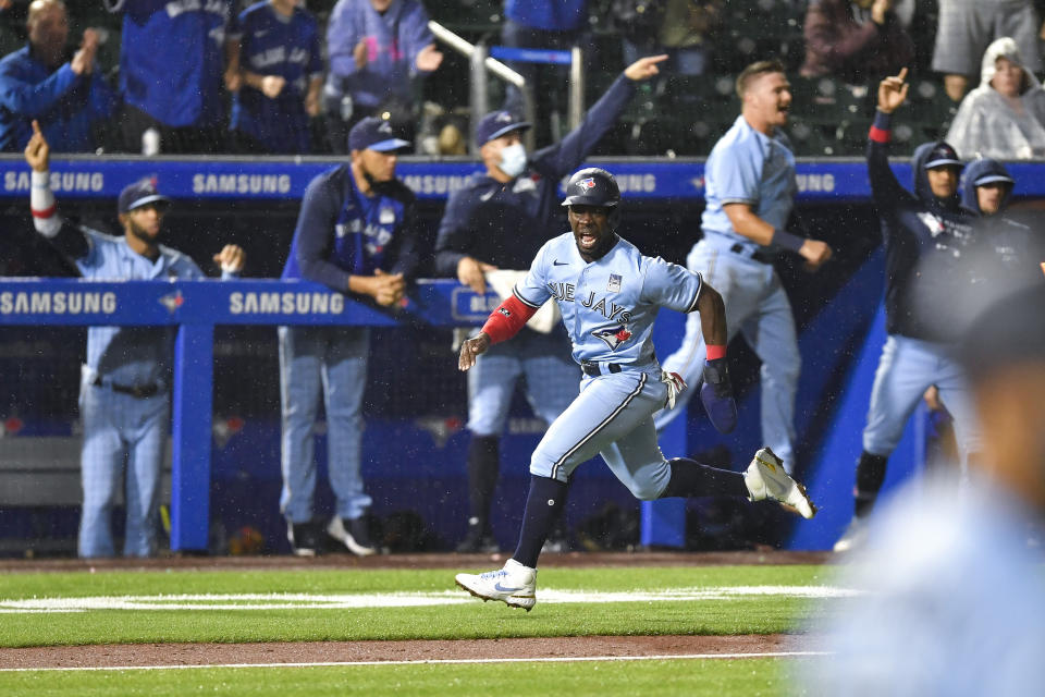 Toronto Blue Jays' Jonathan Davis (3) heads home to score against the Miami Marlins on a two-run triple by Bo Bichette during the ninth inning of a baseball game in Buffalo, N.Y., Wednesday, June 2, 2021. The Blue Jays won 6-5. (AP Photo/Adrian Kraus)