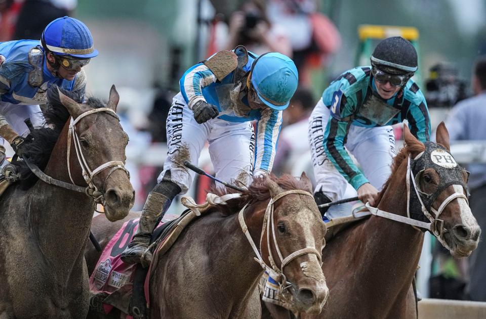 Winning jockey Javier Castellano, center, clinches his fist in celebration aboard Mage as jockey Jareth Loveberry looks on from second-place Two Phil's, right, after the 149th Kentucky Derby Saturday at Churchill Downs in Louisville, Ky. At left is third-place Angel of Empire ridden by Falvien Prat. May, 6, 2023.