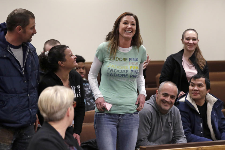 Jamie Cline, recovering from a 10-year heroin addiction, smiles as she is named the winner of a small raffle at a drug court session in Thurston County Superior Court Tuesday, Dec. 17, 2019, in Olympia, Wash. While in a jail work-release program this past spring, Cline took a medication called buprenorphine. A new treatment philosophy called "medication first" scraps requirements for counseling, abstinence or even a commitment to recovery. (AP Photo/Elaine Thompson)