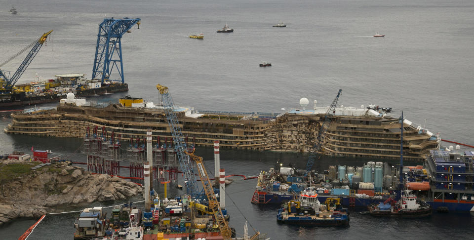 FILE -- In this Sept. 17, 2013 file photo, The Costa Concordia is seen after it was lifted upright on the Tuscan Island of Giglio, Italy. One of the tanks fastened to the shipwrecked Costa Concordia cruise liner to help prepare it for removal to land has shifted, Tuesday, may 6, 2014. The consortium overseeing the operation said in a statement that the cause was under investigation and that there was no damage to the ship. Workers fastened the first tank to the starboard side of the ship last week. The tanks, 19 in all, were being filled with water to help stabilize the Concordia, now resting on an artificial seabed after it was set upright in September. (AP Photo/Andrew Medichini)