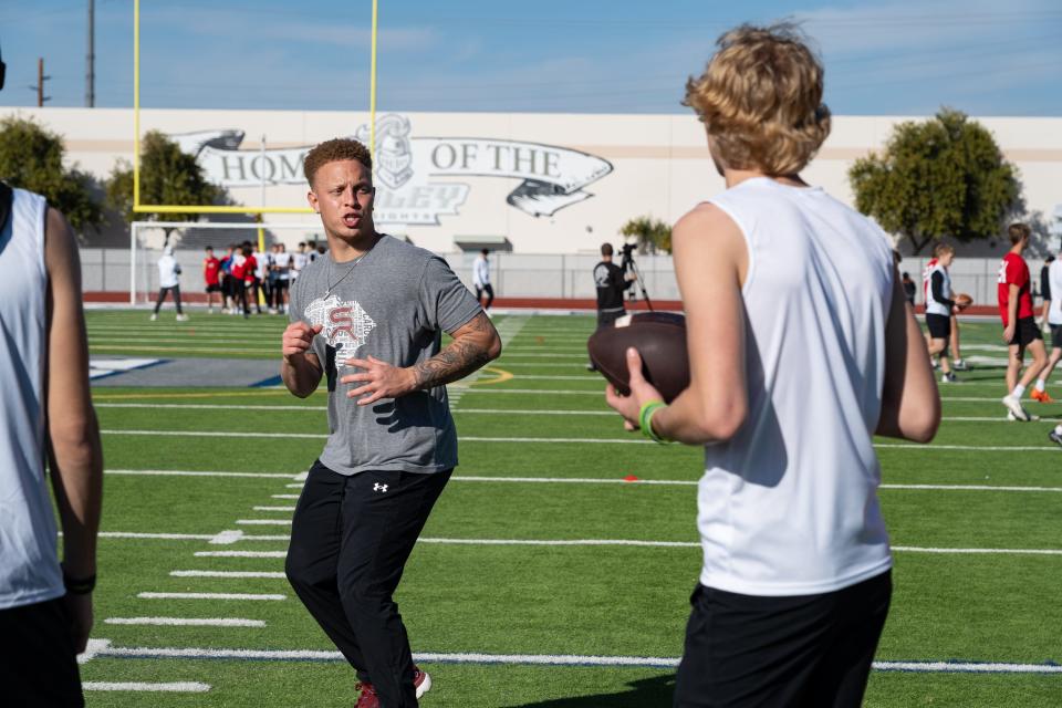 Former Pinnacle High School quarterback Spencer Rattler works with high school athletes at a quarterback camp at Higley High School on Jan. 6, 2024, in Gilbert.