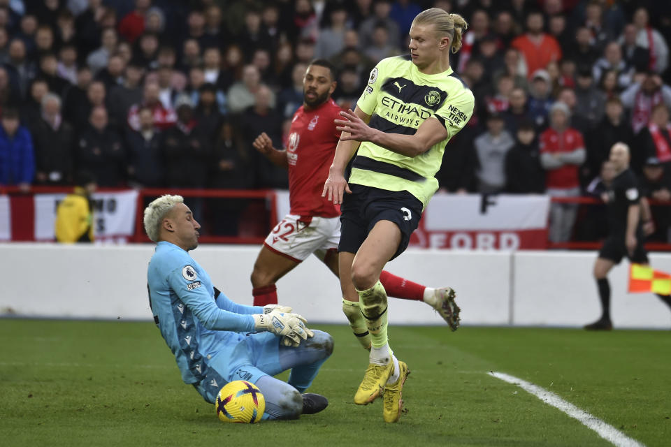 Manchester City's Erling Haaland, right, challenges for the ball with Nottingham Forest's Keylor Navas during the English Premier League soccer match between Nottingham Forest and Manchester City at City ground in Nottingham, England, Saturday, Feb. 18, 2023. (AP Photo/Rui Vieira)