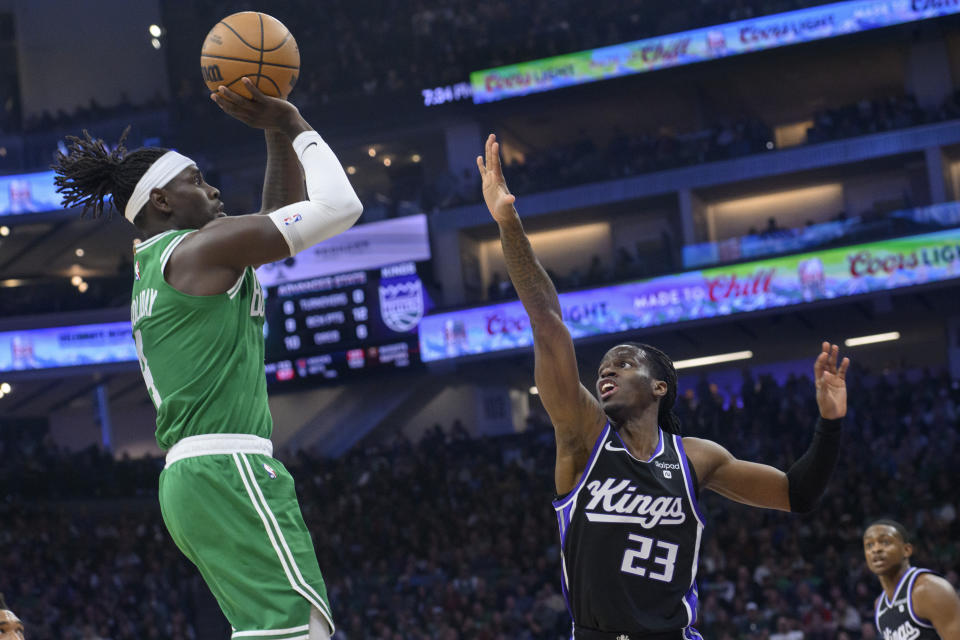 Boston Celtics guard Jrue Holiday shoots over Sacramento Kings guard Keon Ellis (23) during the first quarter of an NBA basketball game in Sacramento, Calif., Wednesday, Dec. 20, 2023. (AP Photo/Randall Benton)