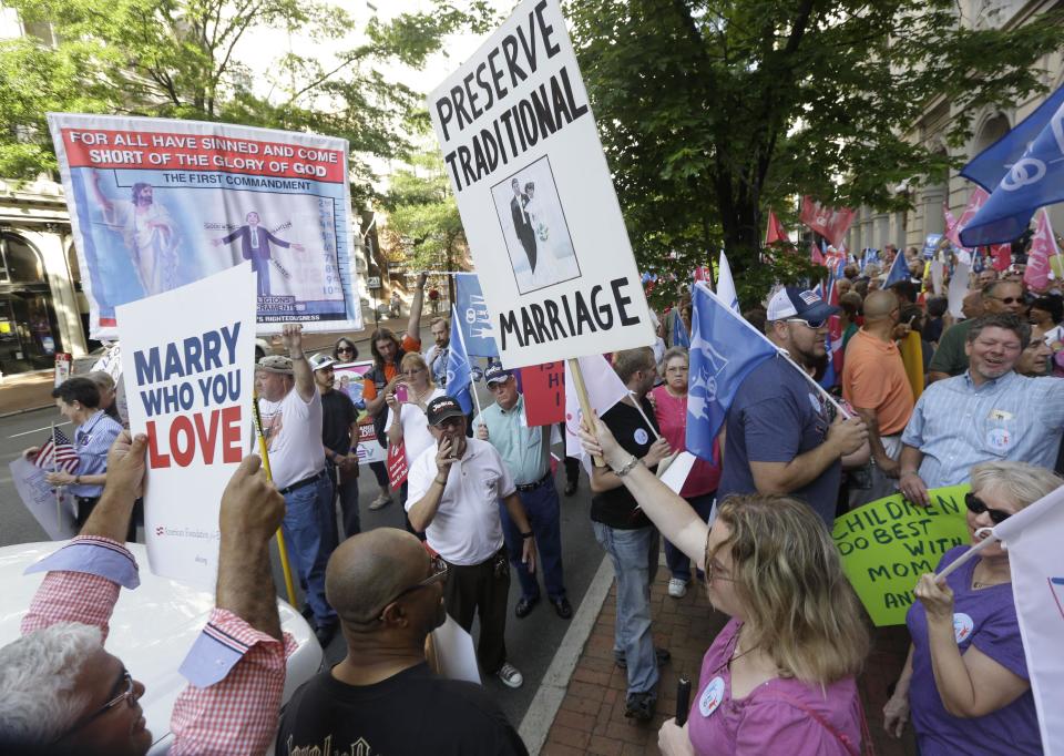 Supporters of traditional marriage and gay marriage demonstrate outside the Federal Appeals Court in Richmond, Va., Tuesday, May 13, 2014. The 4th U.S. Circuit Court of Appeals in Richmond is taking up the issue of gay marriage, with arguments scheduled on a ruling that the state's ban on such unions is unconstitutional. (AP Photo/Steve Helber)