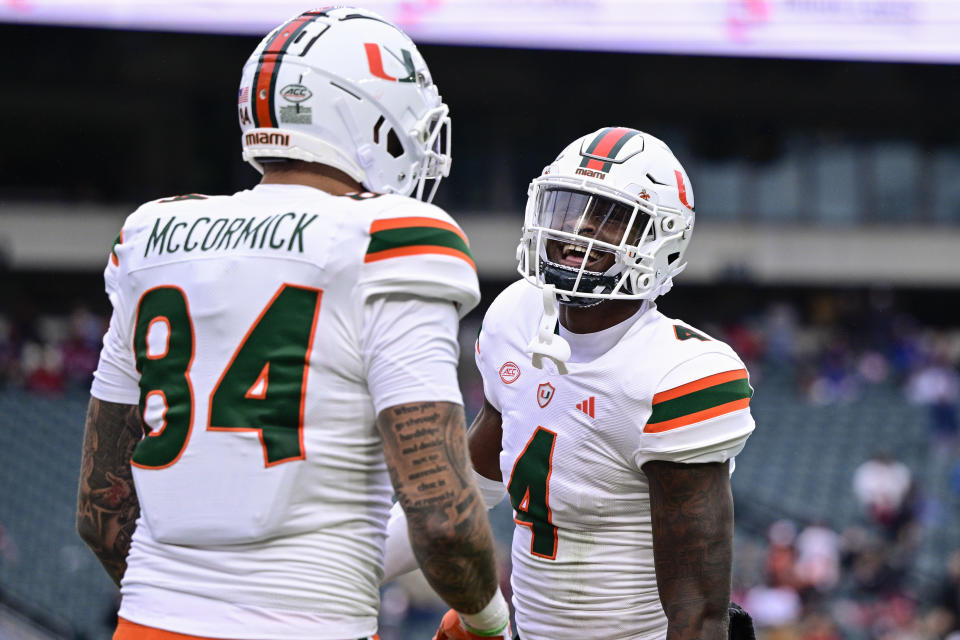 Miami wide receiver Colbie Young (4) celebrates his touchdown with Cam McCormick during the first half of an NCAA college football game against Temple, Saturday, Sept. 23, 2023, in Philadelphia. (AP Photo/Derik Hamilton)