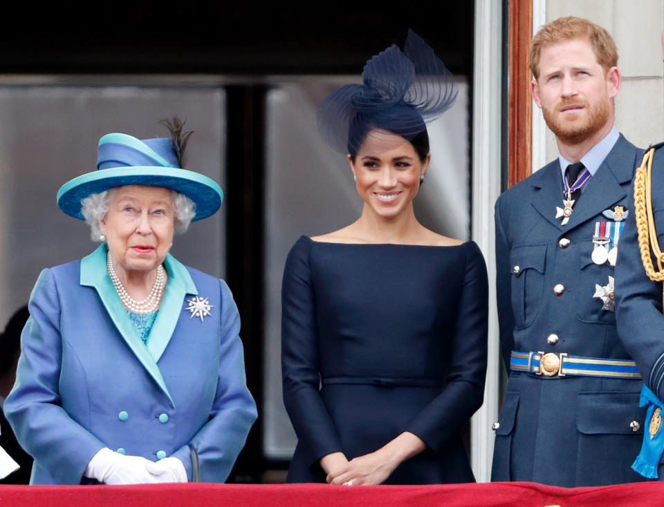 LONDON, UNITED KINGDOM - JULY 10: (EMBARGOED FOR PUBLICATION IN UK NEWSPAPERS UNTIL 24 HOURS AFTER CREATE DATE AND TIME) Queen Elizabeth II, Meghan, Duchess of Sussex and Prince Harry, Duke of Sussex watch a flypast to mark the centenary of the Royal Air Force from the balcony of Buckingham Palace on July 10, 2018 in London, England. The 100th birthday of the RAF, which was founded on on 1 April 1918, was marked with a centenary parade with the presentation of a new Queen's Colour and flypast of 100 aircraft over Buckingham Palace. (Photo by Max Mumby/Indigo/Getty Images)