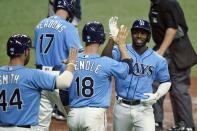 Tampa Bay Rays' Randy Arozarena, right, celebrates with teammates, including Austin Meadows, Joey Wendle and Kevan Smith after his three-run home run off New York Yankees starting pitcher Michael King during the sixth inning of a baseball game Thursday, May 13, 2021, in St. Petersburg, Fla. (AP Photo/Chris O'Meara)