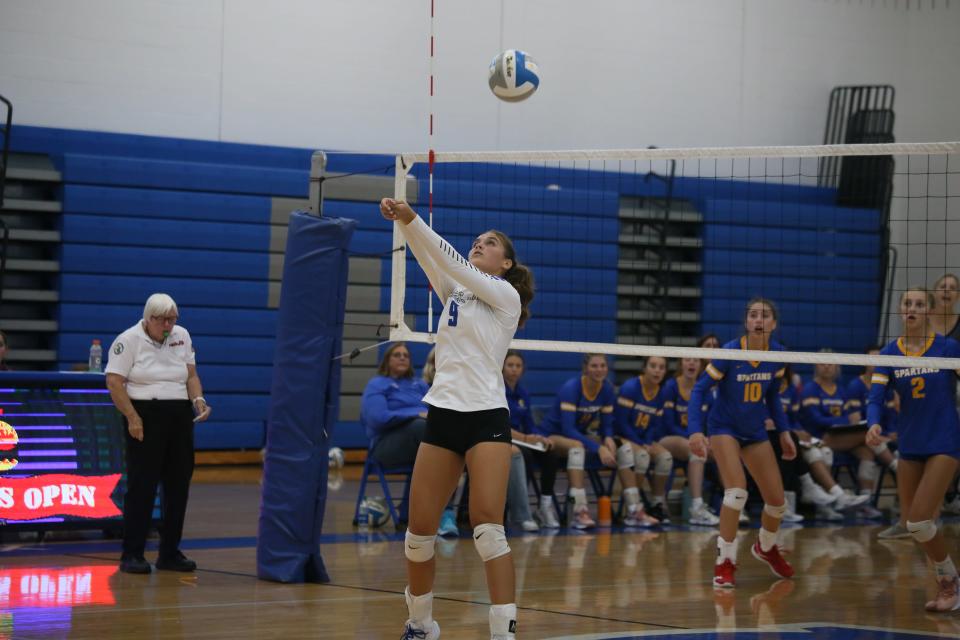 Croswell-Lexington's Ava Oleski sets the ball for a kill during a game earlier this season. The Pioneers will face North Branch in a Division 2 district final on Thursday.