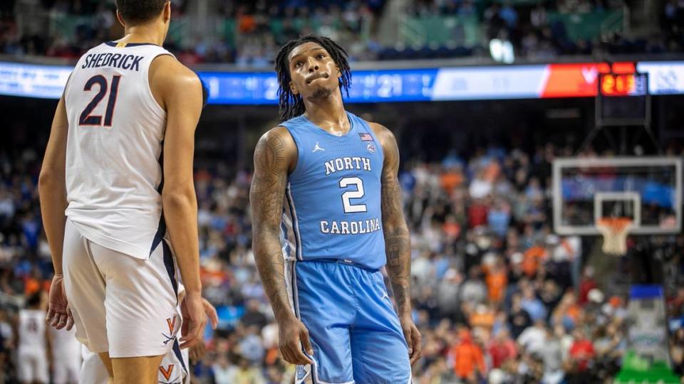 Down by nine points with just seconds to play, North Carolina’s Caleb Love (2) glances at the scoreboard during the third round of the ACC Tournament on Thursday, March 9, 2023 at the Greensboro Coliseum in Greensboro, N.C. Love scored 11 points in the 68-59 loss. Robert Willett/rwillett@newsobserver.com