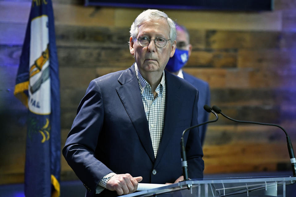 FILE - In this April 5, 2021, file photo Senate Minority Leader Mitch McConnell, R-Ky., listens to a reporter's question during a news conference at a COVID-19 vaccination site in Lexington, Ky. For decades the GOP and business have shared common ground, especially with their mutual belief in low taxes and the need to repeal regulations. But the relationship has come under increasing pressure as companies take cultural stands and other interests diverge. (AP Photo/Timothy D. Easley, File)