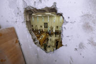 Israeli security forces inspect a damaged synagogue after it was hit by a rocket fired from the Gaza Strip, in Ashkelon, Israel, Sunday, May 16, 2021. (AP Photo/Tsafrir Abayov)