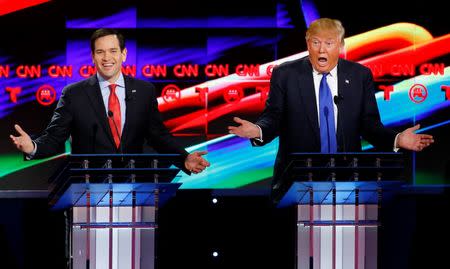 Marco Rubio and Donald Trump react to each other as they discuss an issue during the debate sponsored by CNN for the 2016 Republican U.S. presidential candidates in Houston, Texas, February 25, 2016. REUTERS/Mike Stone