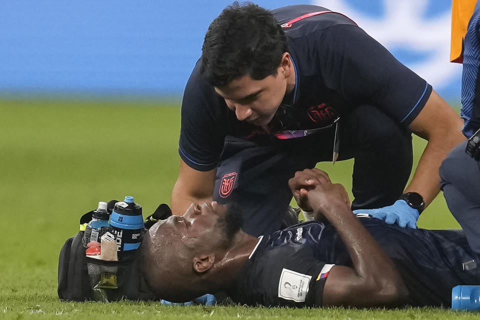 Ecuador's Enner Valencia is attended by medical personnel during the World Cup group A soccer match between Netherlands and Ecuador, at the Khalifa International Stadium in Doha, Qatar, Friday, Nov. 25, 2022. (AP Photo/Darko Vojinovic)