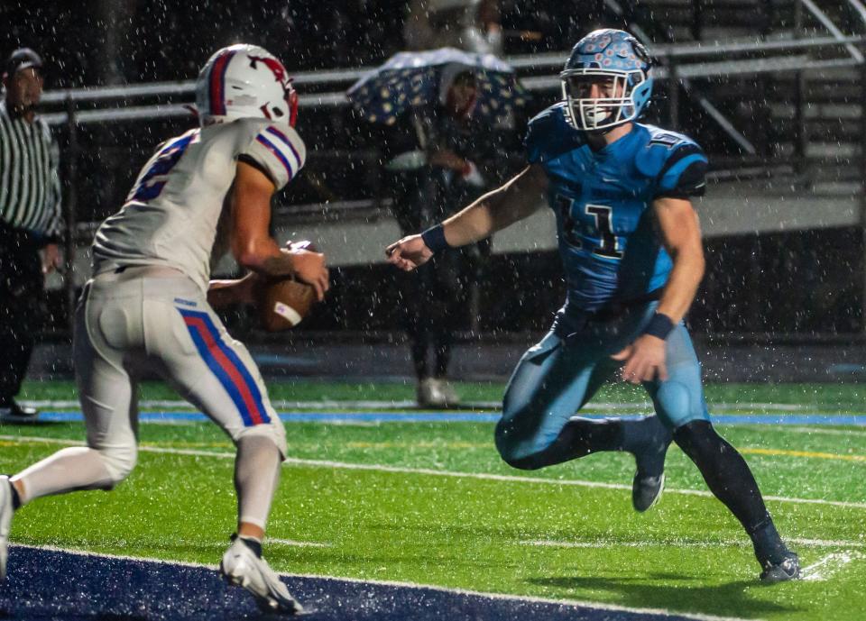 Central Valley's Matt Gerovac eyes Laurel Highlands QB Rodney Gallagher, who barely escapes the end zone for 4th down during their WPIAL playoff game Friday at Central Valley High School. [Lucy Schaly/For BCT]