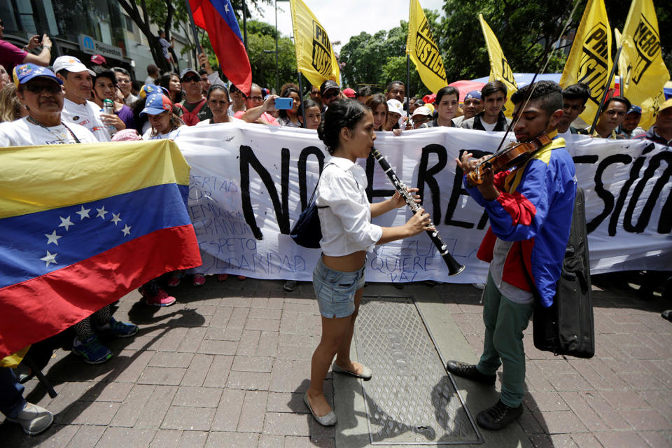 <p>Young musicians play music during a gathering to pay homage to victims of violence during the protest against Venezuela’s President Nicolas Maduro’s government in Caracas, Venezuela, May 7, 2017. (Photo: Marco Bello/Reuters) </p>