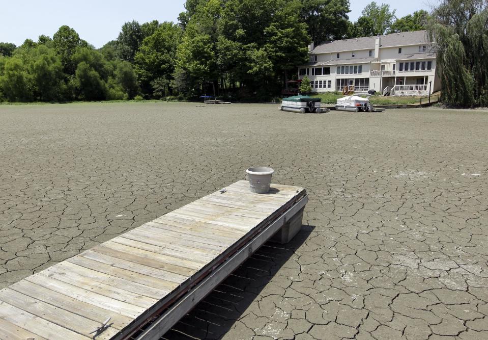 A dock extends into a dry cove at Morse Reservoir in Noblesville, Ind., Thursday, July 5, 2012. The reservoir is down 3.5 feet from normal levels. Oppressive heat is slamming the middle of the country with record temperatures that aren’t going away after the sun goes down. Temperatures exceeded 100 degrees in Central Indiana. (AP Photo/Michael Conroy)