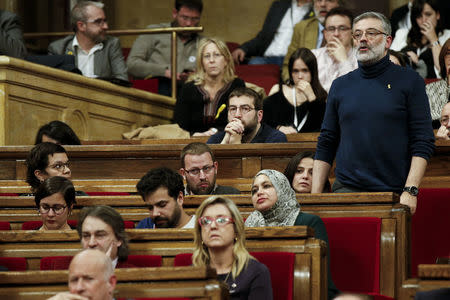 Leftist CUP party leader Carles Riera votes from his seat during a investiture session of Jordi Turull as new Catalan President at regional parliament in Barcelona, Spain, March 22, 2018. REUTERS/Albert Gea