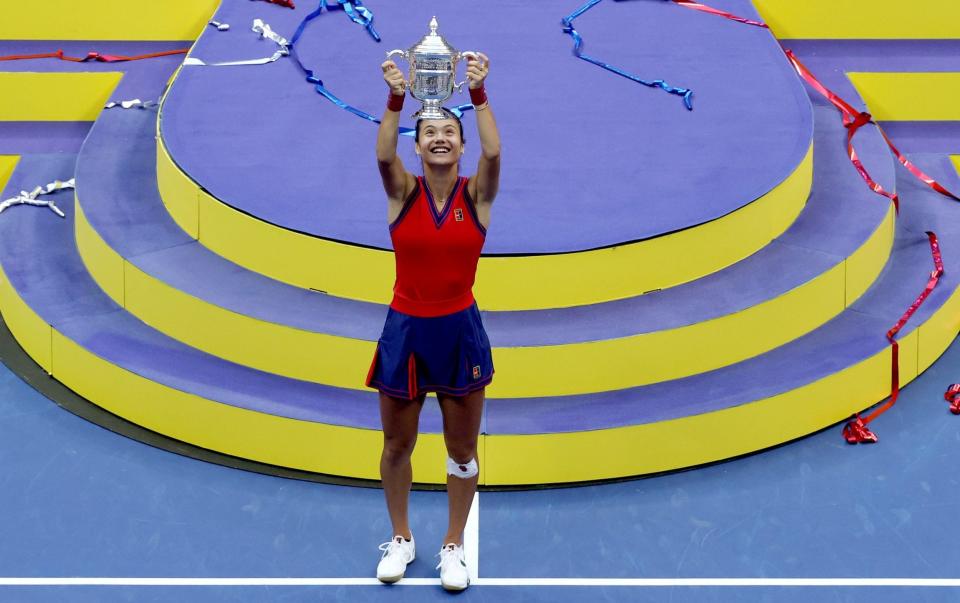 Emma Raducanu of Great Britain celebrates with the championship trophy after defeating Leylah Annie Fernandez of Canada during their Women's Singles final match on Day Thirteen of the 2021 US Open at the USTA Billie Jean King National Tennis Center on September 11, 2021 in the Flushing neighborhood of the Queens borough of New York City. - GETTY IMAGES