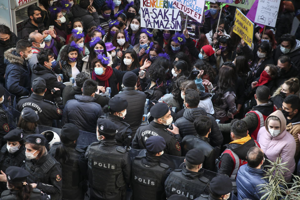 Protesters chant slogans in front of police officers during a rally to mark International Women's Day in Istanbul, Monday, March 8, 2021.Thousands of people joined the march to denounce violence against women in Turkey, where more than 400 women were killed last year. The demonstrators are demanding strong measures to stop attacks on women by former partners or family members as well as government commitment to a European treaty on combatting violence against women. (AP Photo/Emrah Gurel)