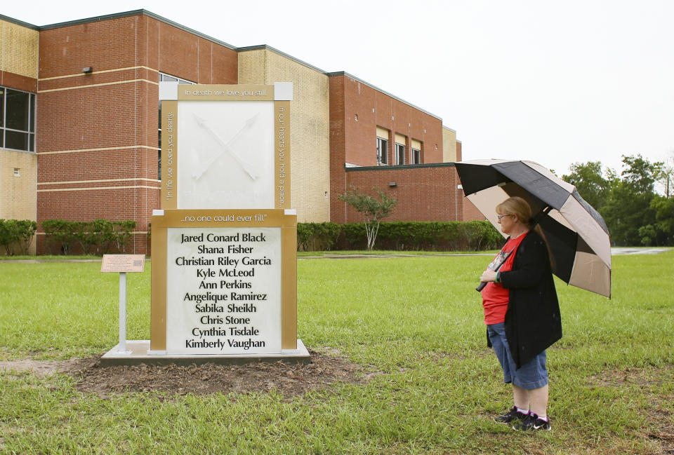 Gail McLeod, mother of Kyle McLeod, looks at a memorial in honor of the victims, including her son, in the 2018 school shoot at Santa Fe High School on Sunday, May 16, 2021. May 18 marks the third year anniversary of the deadly shooting at the school. (Elizabeth Conley/Houston Chronicle via AP)