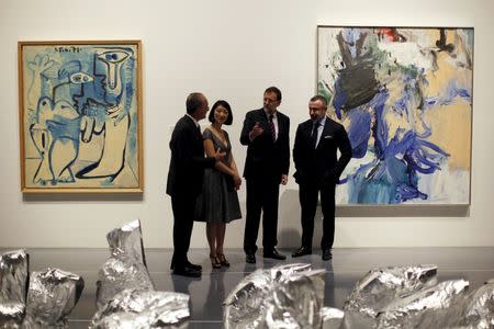 (L-R) Malaga's Mayor Francisco de la Torre, French Culture Minister Fleur Pellerin, Spain's Prime Minister Mariano Rajoy and Centre Pompidou President Alain Seban pose for photographers next to the artworks "Couple" (L) by Pablo Picasso, the installation "Ghost" by French artist Kader Attia and "Untitled XX" (R) by Dutch-born artist Willem de Kooning during the opening ceremony of the Malaga branch of the Centre Pompidou in Malaga, southern Spain March 28, 2015. REUTERS/Jon Nazca