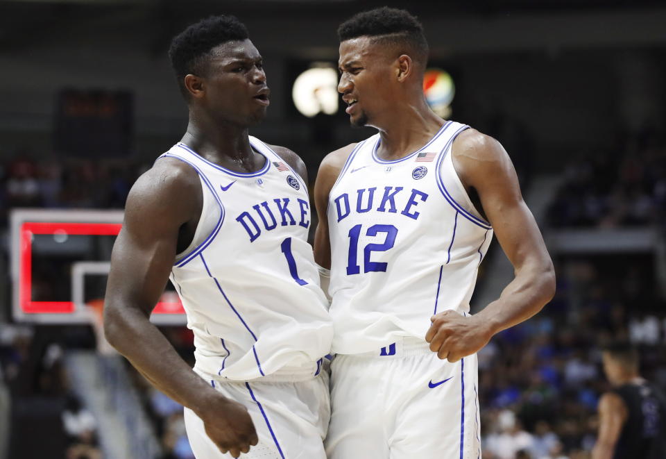 FILE - In this Aug. 15, 2018, file photo, Duke's Zion Williamson, left, and Javin DeLaurier celebrate during the team's exhibition basketball game against Ryerson in Mississauga, Ontario. The Duke juggernaut heads to paradise, where college basketball's most talked-about team will be even more in the spotlight at the Maui Invitational. The top-ranked Blue Devils should be able to handle it. They're 5 for 5 at the Lahaina Civic Center: five trips to Maui, five additions to the already-full trophy case for the trip home. This, of course, is a new team with new stars like Barrett and Williamson, but these freshmen have embraced the spotlight's glare so far and there's little reason to believe it will be any different in Maui. (Mark Blinch/The Canadian Press via AP, File)