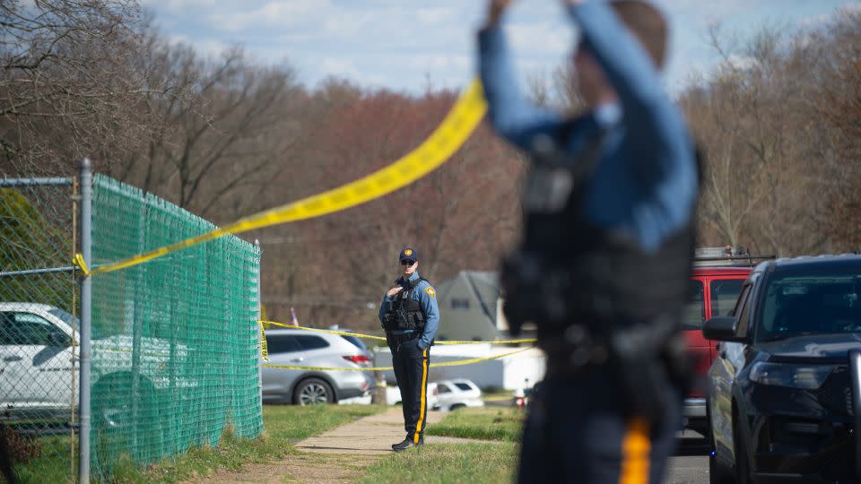 Police officers from the Falls Township Police Department tape off the scene of a shooting on March 16, 2024, in Levittown, Pennsylvania. - Matthew Hatcher/Getty Images