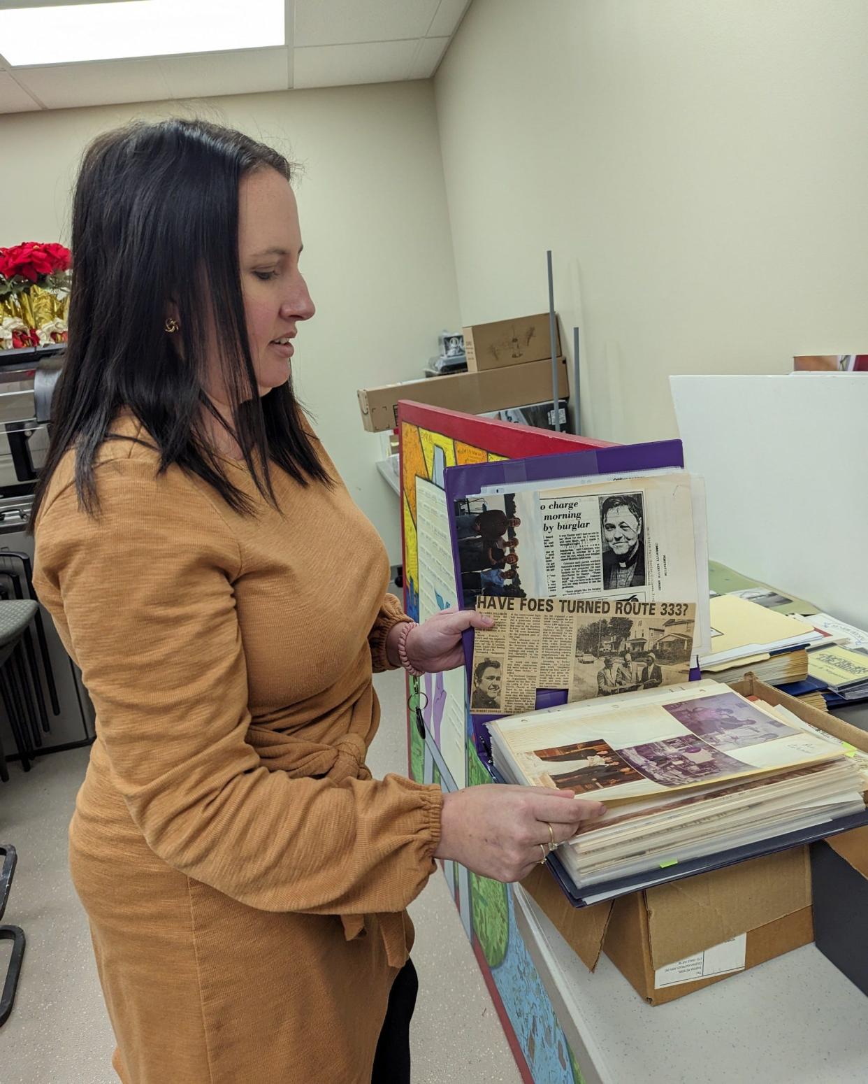 JRC CEO Julie Abiecunas looks at some of their archives. The nonprofit celebrates its 50th anniversary this year.