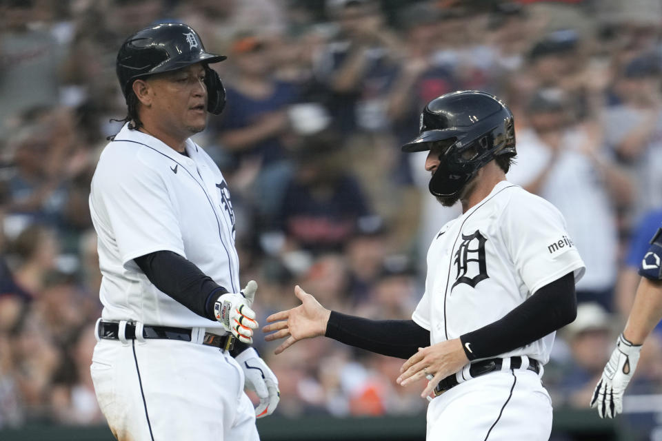 Detroit Tigers' Miguel Cabrera, left, and Eric Haase, right, celebrate scoring against the Minnesota Twins in the second inning of a baseball game, Saturday, June 24, 2023, in Detroit. (AP Photo/Paul Sancya)