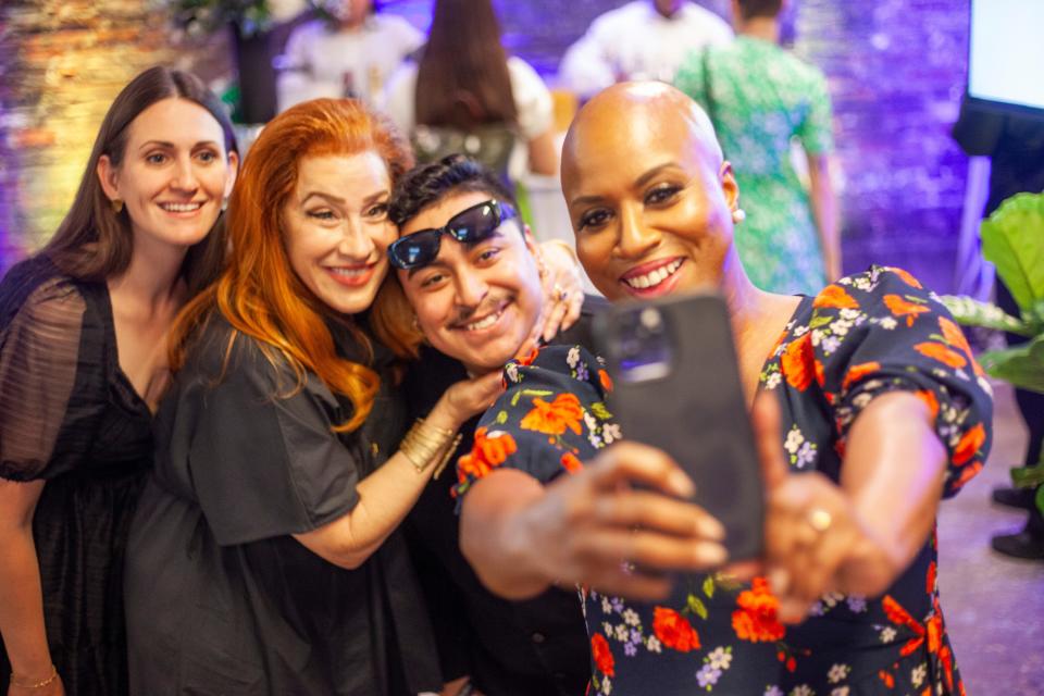 Representative Ayanna Pressley (D-Mass.) takes a selfie at the evening celebration at Union Market with Lisa Ann Walter and attendees.