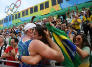 <p>Alison Cerutti of Brazil celebrates in the crowd after match point in the Men’s Beach Volleyball Quarterfinal match between the United States and Brazil on Day 10 of the Rio 2016 Olympic Games at the Beach Volleyball Arena on August 15, 2016 in Rio de Janeiro, Brazil. (Photo by Matthias Hangst/Getty Images) </p>