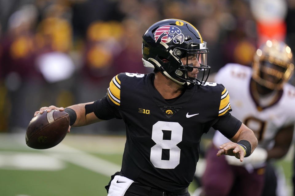 Iowa quarterback Alex Padilla (8) throws a pass during the first half of an NCAA college football game against Minnesota, Saturday, Nov. 13, 2021, in Iowa City, Iowa. (AP Photo/Charlie Neibergall)