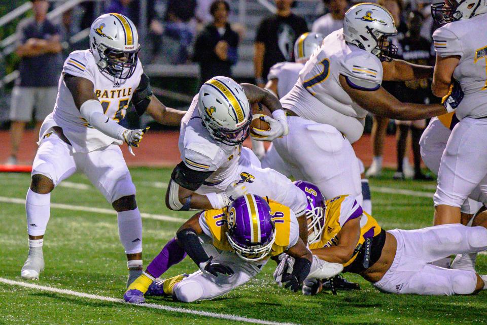 Battle's Rickie Dunn Jr. (8) scores the Spartans' second touchdown of the night, barreling over Hickman's Quin'Tavion Jacobs (16) during Battle's 47-29 win over the Kewpies on Friday night.