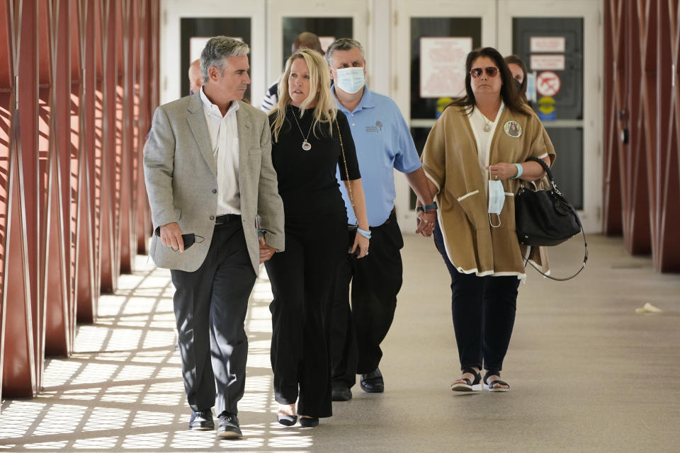 FILE - Tom and Gena Hoyer, left, the parents of Parkland victim Luke Hoyer, and Tony and Jennifer Montalto, the parents of slain student Gina Montalto, leave the Broward County Courthouse in Fort Lauderdale, Fla., Wednesday, Oct. 20, 2021, following Marjory Stoneman Douglas High School shooter Nikolas Cruz's guilty plea on all 17 counts of premeditated murder and 17 counts of attempted murder in the 2018 shootings. (AP Photo/Wilfredo Lee, File)