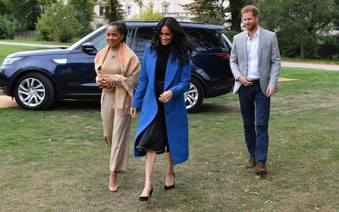 The Duke and Duchess with Meghan's mother, Doria (left) - Credit: BEN STANSALL&nbsp;/AFP