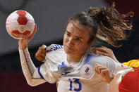 <p>Russia's right back Anna Vyakhireva is challenged during the women's quarterfinal handball match between Montenegro and Russia of the Tokyo 2020 Olympic Games at the Yoyogi National Stadium in Tokyo on August 4, 2021. (Photo by Fabrice COFFRINI / AFP)</p> 