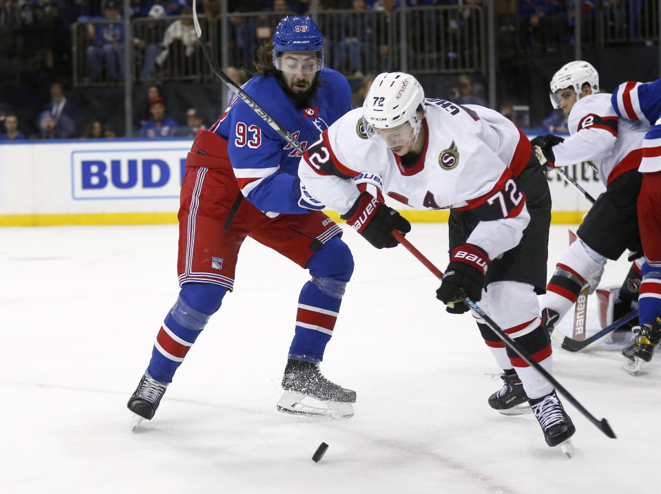 New York Rangers center Mika Zibanejad (93) and Ottawa Senators defenseman Thomas Chabot vie for the puck during the second period of an NHL hockey game Friday, Dec. 2, 2022, in New York. (AP Photo/John Munson)