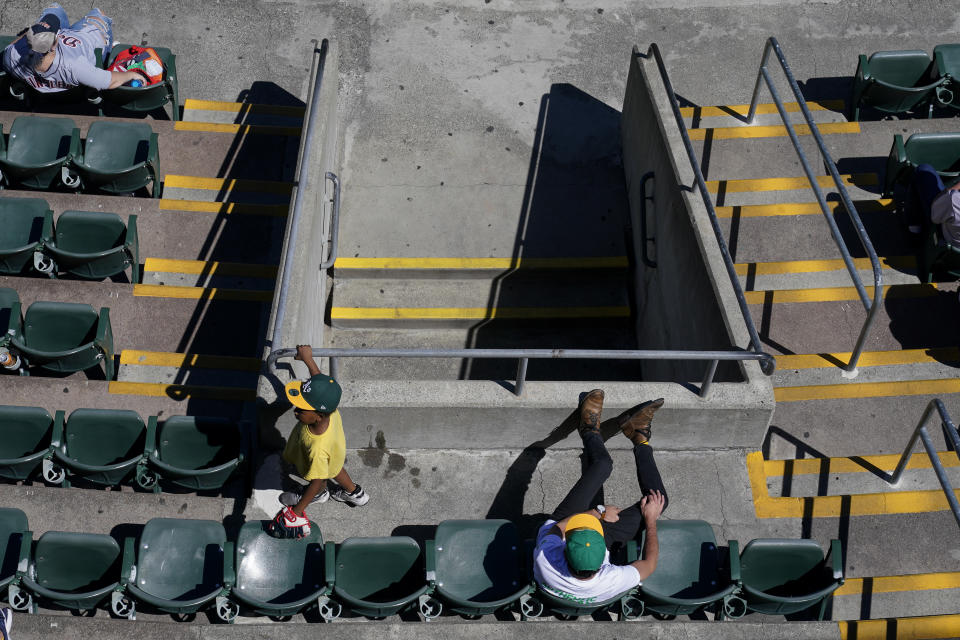 Fans attend the first baseball game of a doubleheader between the Oakland Athletics and the Detroit Tigers in Oakland, Calif., Thursday, July 21, 2022. (AP Photo/Godofredo A. Vásquez)