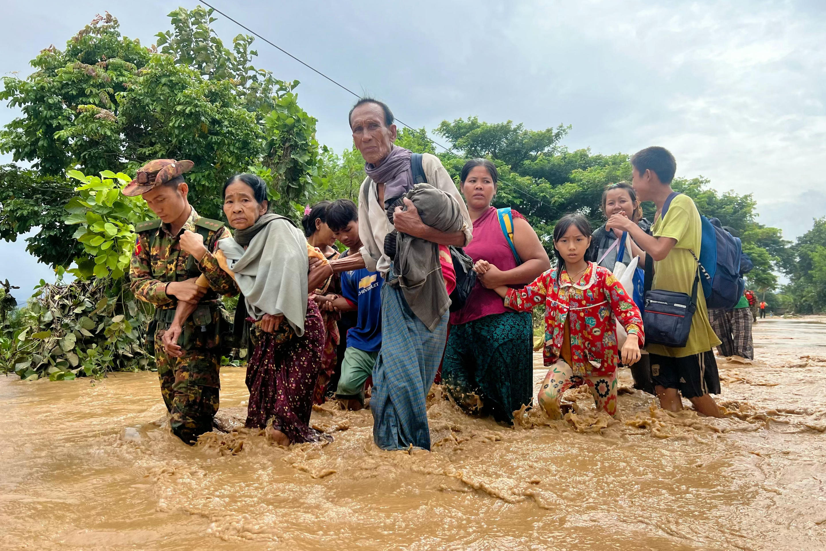 Residents walk through floodwaters in Pyinmana, Naypyidaw region of Myanmar on September 13, 2024. (Sai ​​​​Aung Main/AFP via Getty Images)