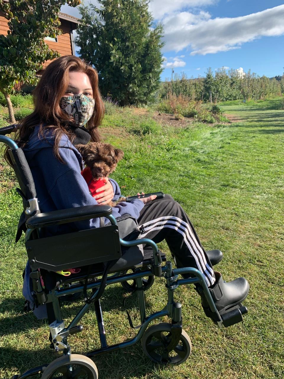 Kaya sitting outside with her dog