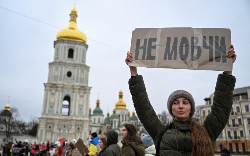 Relatives of the Azovstal defenders and other Ukrainian prisoners of war hold banners as they attend a rally calling for authorities to return their relatives from Russian captivity