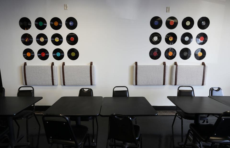 Record albums decorate the walls in the dining room inside Melt 502 in Louisville, Ky. on Jan. 18, 2022.  