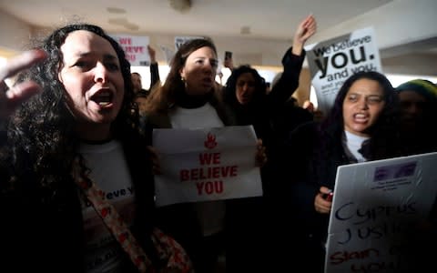 Protesters chant in support of the teenager outside the court house in Paralimni - Credit: AP