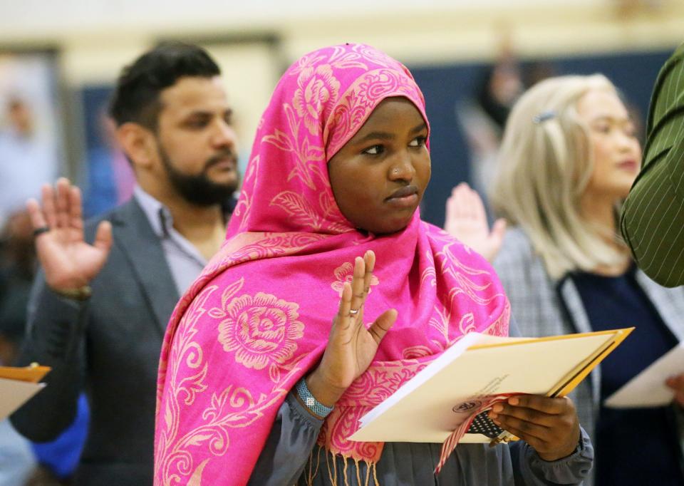 Nasroekad of Kenya takes the Oath of Allegiance as she becomes a U.S. citizen with others at the Middle School of the Kennebunks May 3, 2024.
