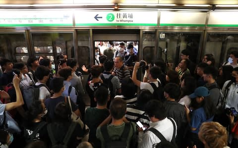 Activists blocked train doors, playing havoc with services  - Credit: RITCHIE B TONGO/EPA