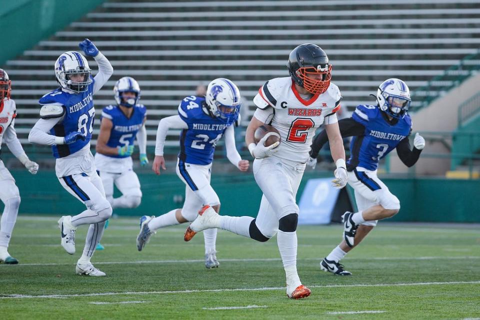 The Middletown defense chases West Warwick's Josh Pedus in the Division III Super Bowl, 11/18/23 at Cranston Stadium.