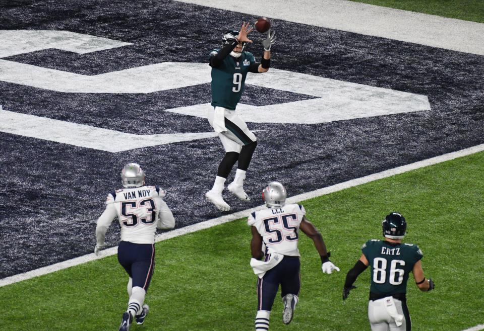 Philadelphia Eagles quarterback Nick Foles (9) catches a touchdown pass against the New England Patriots in the second quarter in Super Bowl 52 at U.S. Bank Stadium.