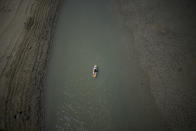 FILE - A paddle boarder passes through a drying portion of the Verdon Gorge in southern France, Tuesday, Aug. 9, 2022. France was in the midst of its fourth heat wave of the year Monday as the country faces what the government warned is its worst drought on record. (AP Photo/Daniel Cole, File)